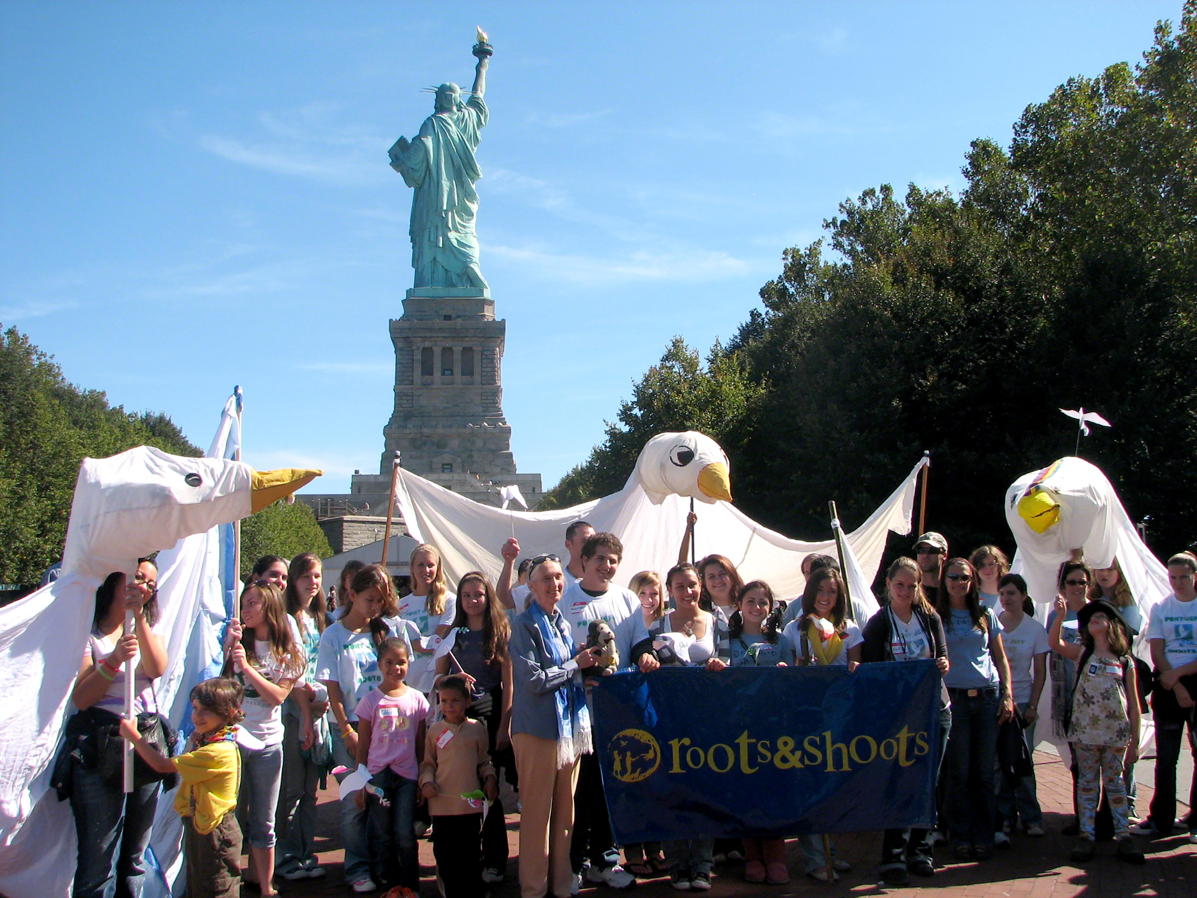 Dr. Jane Goodall and Roots & Shoots members fly a Giant Peace Dove on Liberty Island in New York City for the 2009 Day of Peace.