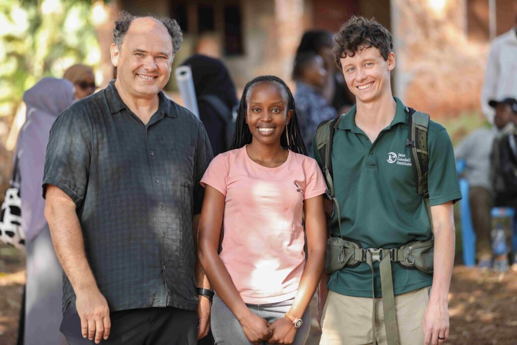 Three researchers Lilian Pintea, Everlene Leilei and Devon Jacobs stand together smiling at Gombe Stream Research Center.