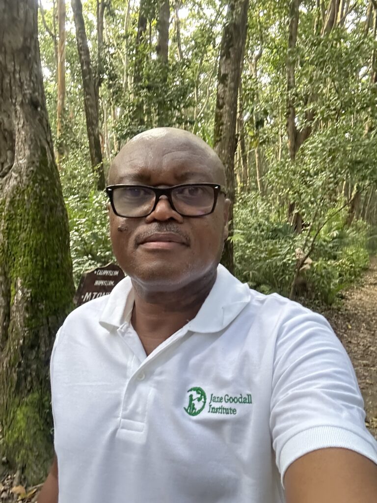Freddy Kimaro smiling wearing JGI polo shirt in Gombe National Park.