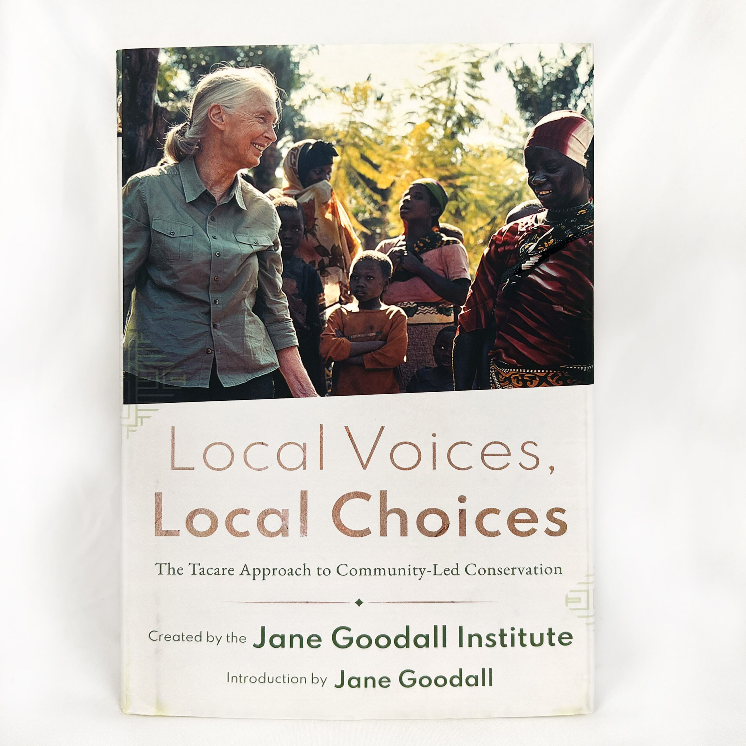 A photo of the front cover of a book titled "Local Voices, Local Choices: The Tacare Approach to Community-Led Conservation."